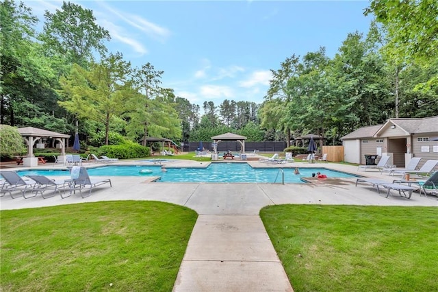 community pool with a gazebo, a yard, a patio area, and fence