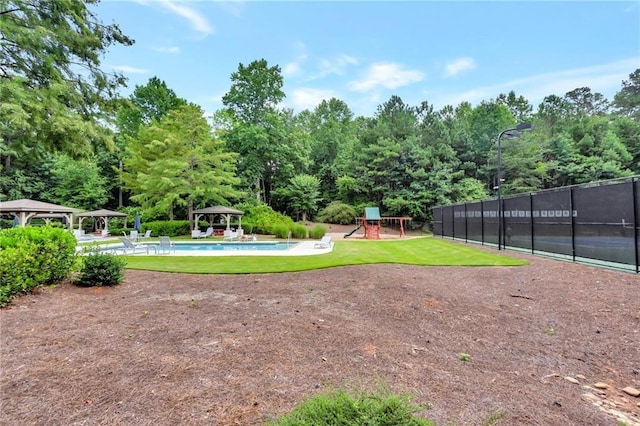 surrounding community featuring fence, a gazebo, playground community, a yard, and a pool