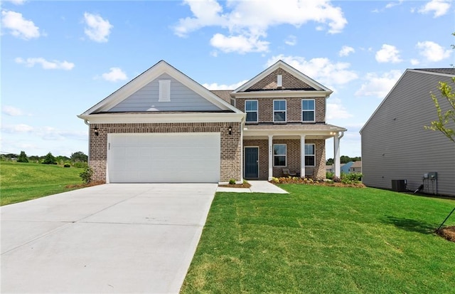 craftsman-style house with driveway, a front yard, a garage, and brick siding