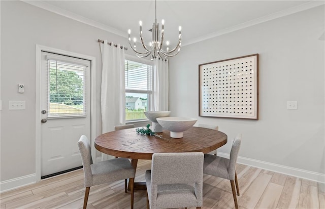 dining room featuring ornamental molding, a notable chandelier, and light wood-type flooring