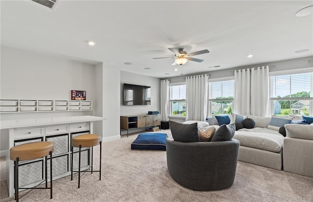 living room featuring light carpet and ceiling fan