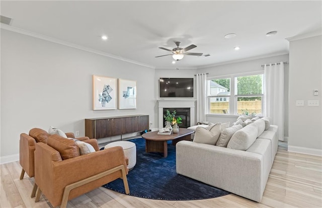 living room with ceiling fan and crown molding