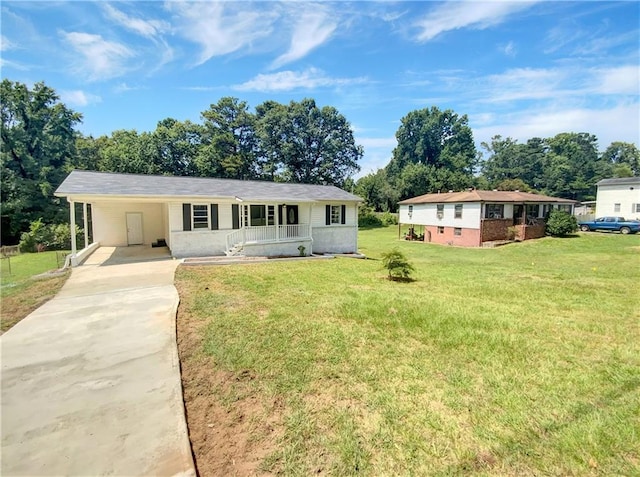 view of front of property with a carport, concrete driveway, covered porch, and a front lawn