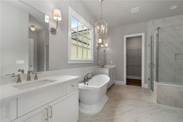 bathroom with vanity, a chandelier, and independent shower and bath