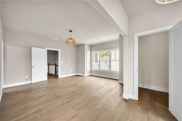 unfurnished living room with wood-type flooring