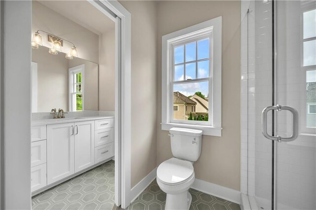 bathroom with vanity, tile patterned flooring, toilet, and walk in shower