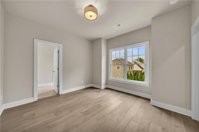 spare room with light wood-type flooring