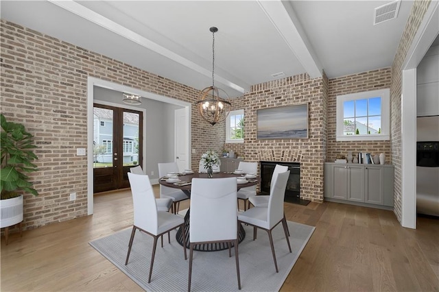 dining room with brick wall and plenty of natural light