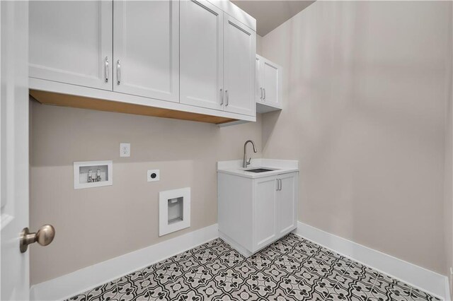 laundry room featuring hookup for an electric dryer, sink, hookup for a washing machine, and cabinets