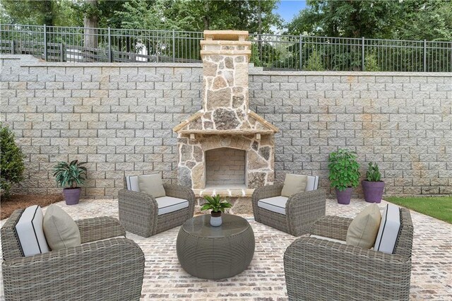 view of patio with an outdoor living space with a fireplace