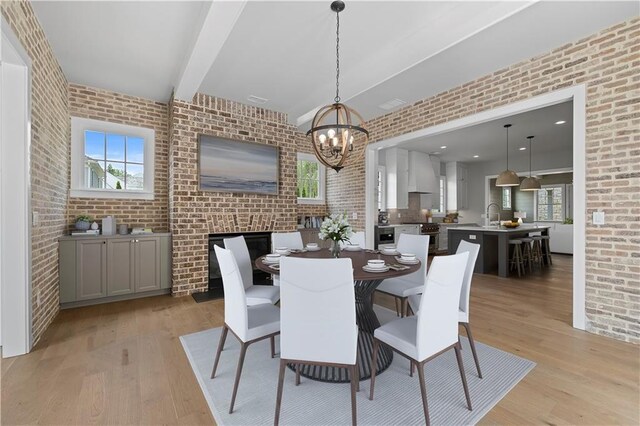 dining space with brick wall and plenty of natural light