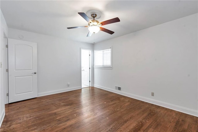 empty room with visible vents, baseboards, and wood finished floors