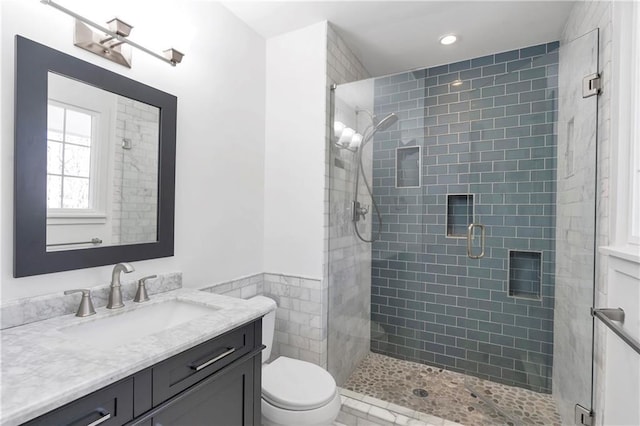 full bath featuring vanity, toilet, recessed lighting, and a stall shower