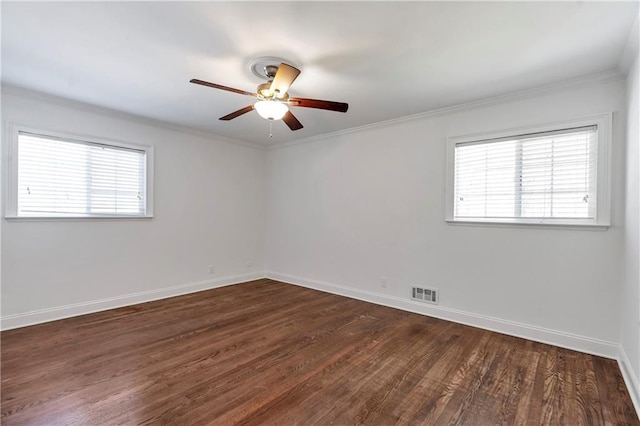 empty room with visible vents, baseboards, a healthy amount of sunlight, and ornamental molding