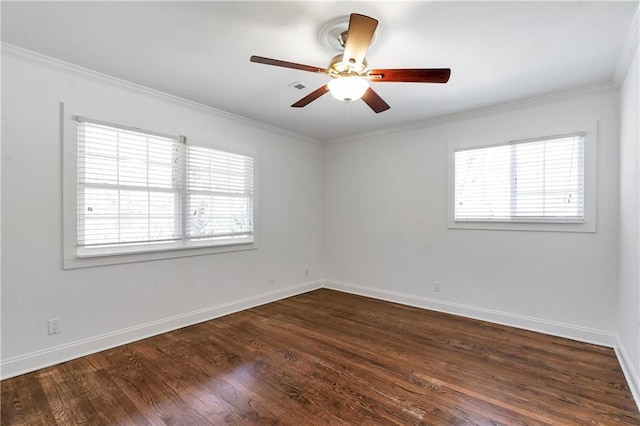 empty room with crown molding, dark wood-style flooring, and a wealth of natural light