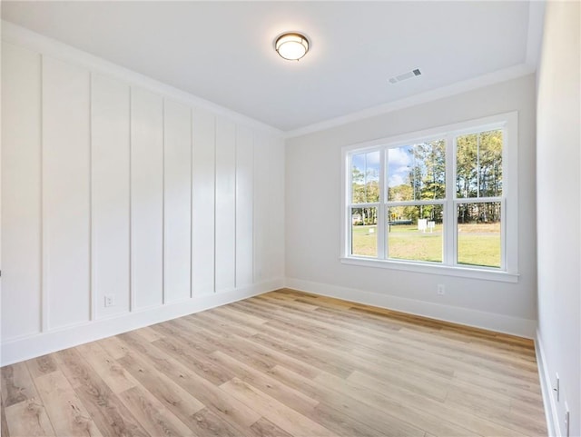 unfurnished room featuring light hardwood / wood-style floors and ornamental molding