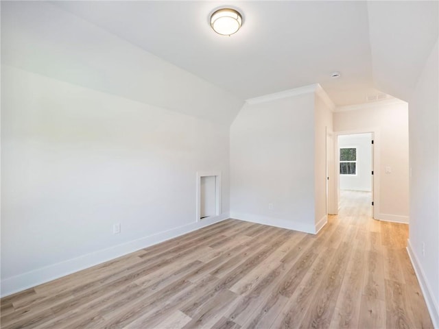 bonus room with light hardwood / wood-style floors and vaulted ceiling