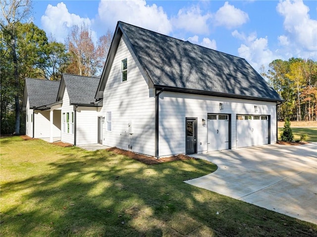 view of side of property with a garage and a lawn