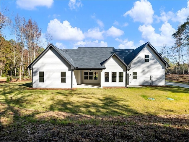 back of house featuring a lawn and a patio area