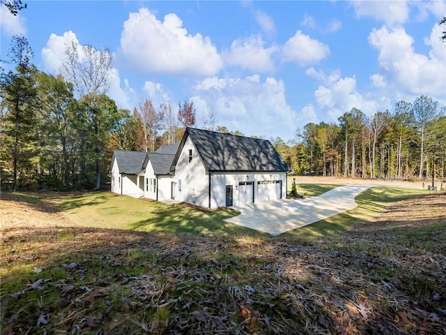 view of home's exterior with a garage and a yard