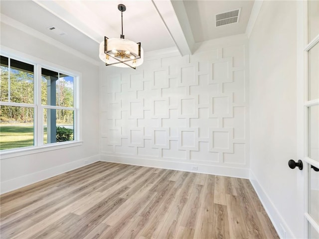 unfurnished dining area featuring beam ceiling and light wood-type flooring