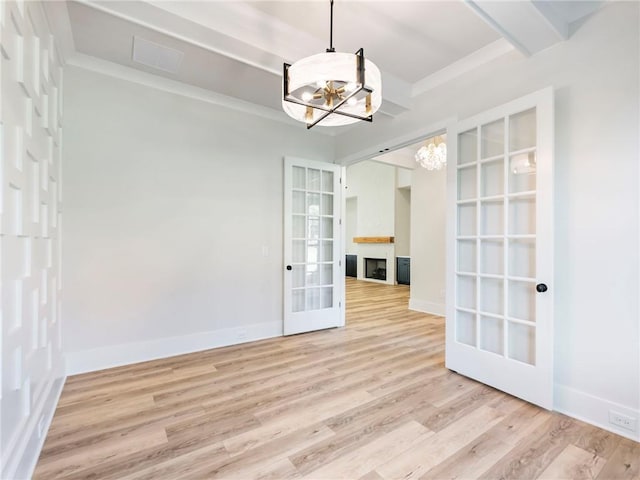 unfurnished dining area featuring light hardwood / wood-style flooring, beam ceiling, and an inviting chandelier