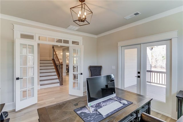 home office featuring a chandelier, wood finished floors, visible vents, ornamental molding, and french doors