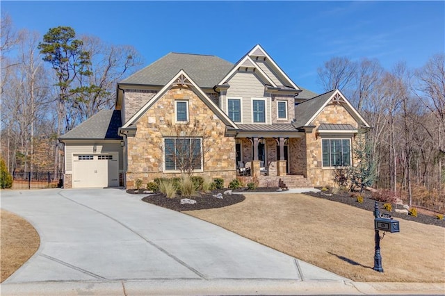 craftsman inspired home with metal roof, a garage, covered porch, driveway, and a standing seam roof