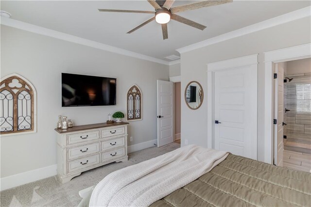 bedroom featuring crown molding, light carpet, ensuite bath, and baseboards