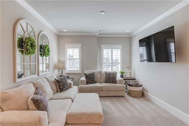 living room with ornamental molding, carpet flooring, visible vents, and baseboards