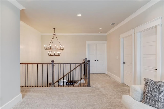 hallway featuring light carpet, visible vents, baseboards, an upstairs landing, and a notable chandelier