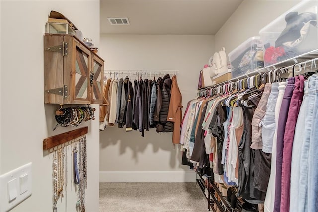 walk in closet featuring visible vents and carpet flooring