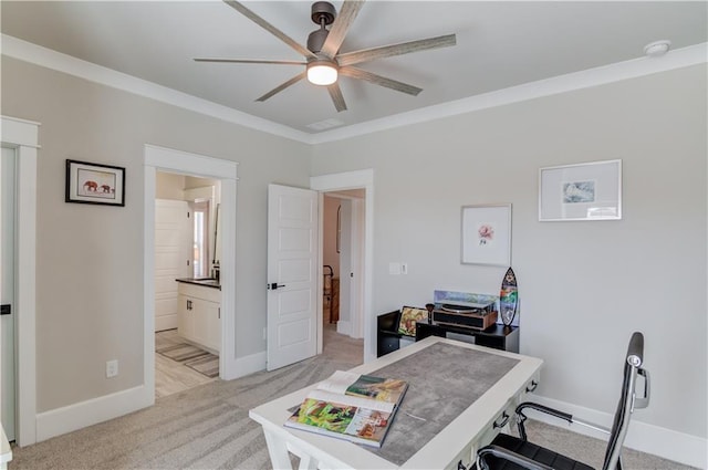 office space with ornamental molding, light colored carpet, ceiling fan, and baseboards