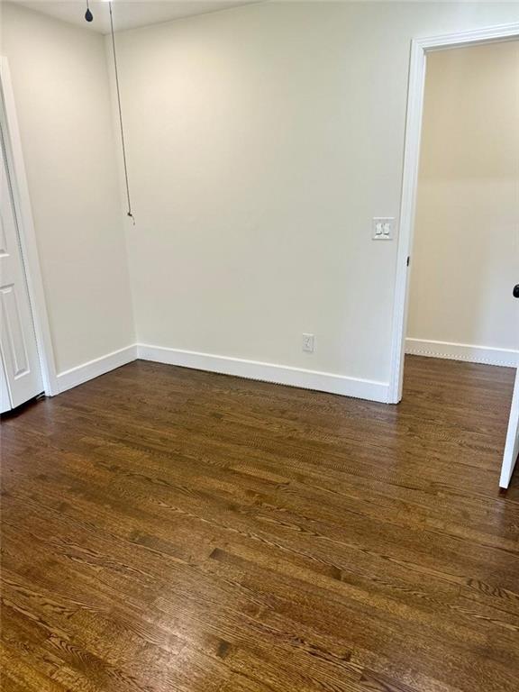 unfurnished room featuring dark hardwood / wood-style floors