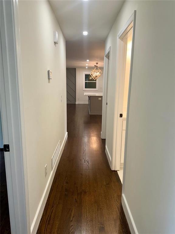 hall with dark hardwood / wood-style flooring