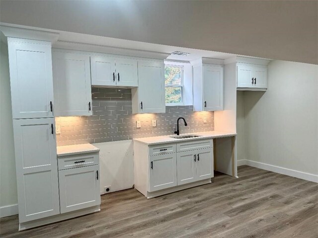 kitchen featuring light hardwood / wood-style floors, sink, and white cabinets