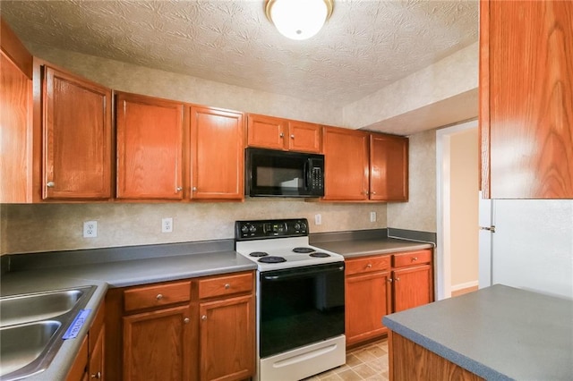 kitchen featuring electric stove, a sink, a textured ceiling, brown cabinetry, and black microwave