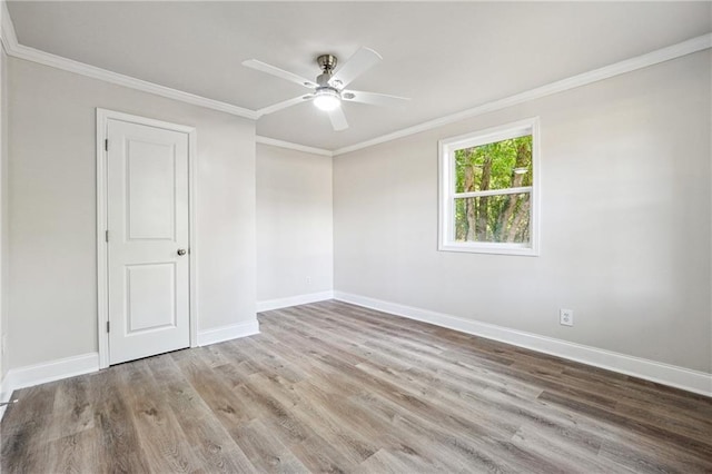 empty room with light hardwood / wood-style flooring, ceiling fan, and ornamental molding