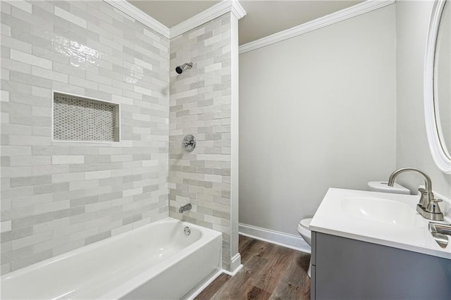 full bathroom with vanity, crown molding, hardwood / wood-style flooring, toilet, and tiled shower / bath