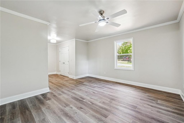 empty room featuring crown molding, ceiling fan, and hardwood / wood-style flooring