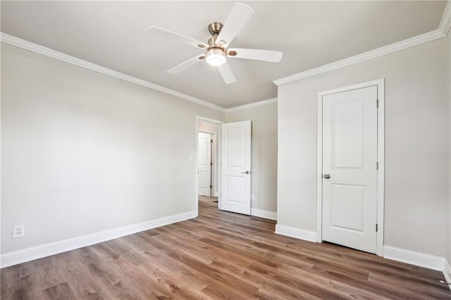 unfurnished bedroom featuring ornamental molding, ceiling fan, and dark hardwood / wood-style flooring