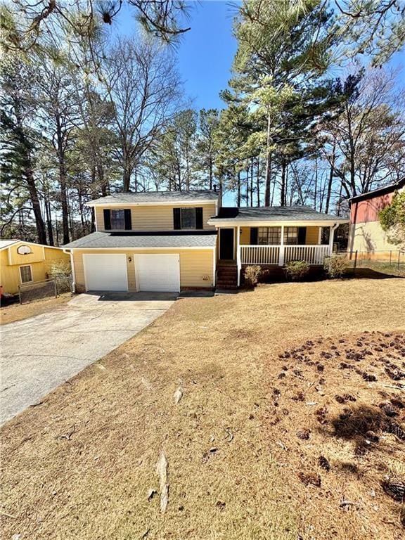 tri-level home featuring a garage, driveway, and a porch