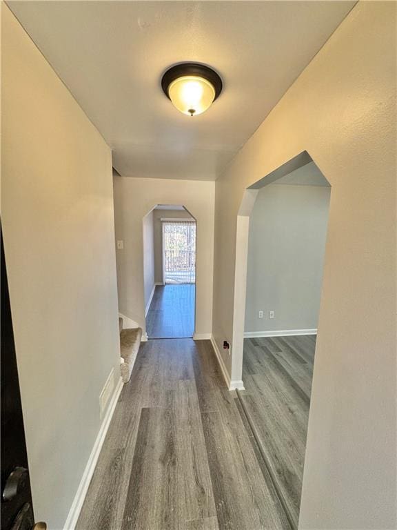 interior space with wood finished floors and baseboards