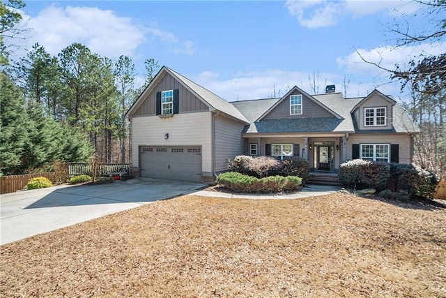 craftsman inspired home with board and batten siding, fence, and concrete driveway