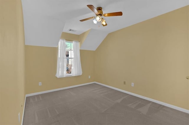 additional living space featuring lofted ceiling, baseboards, visible vents, and carpet flooring