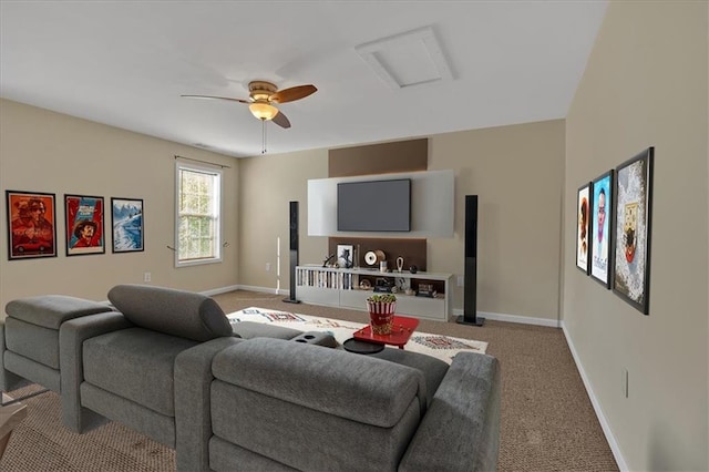 carpeted living area featuring a ceiling fan, attic access, and baseboards