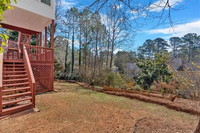 view of yard featuring stairs and a deck