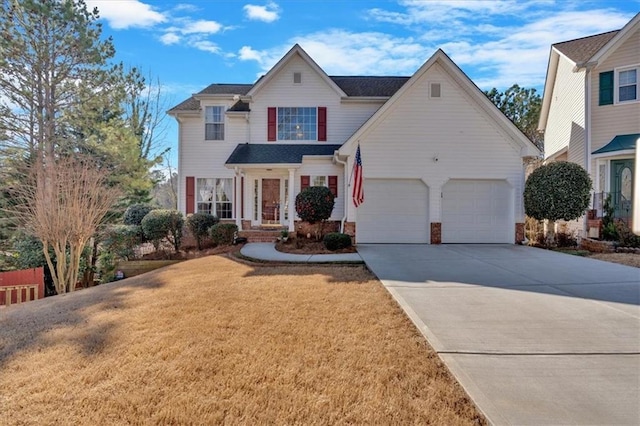 traditional-style home with a garage, driveway, and a front lawn