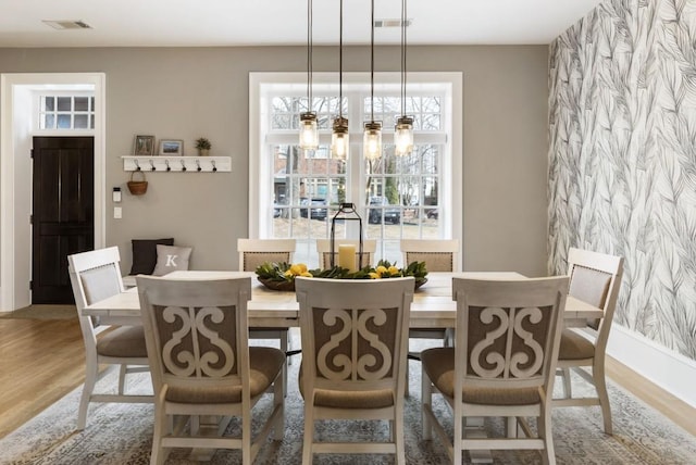 dining room with visible vents and wood finished floors