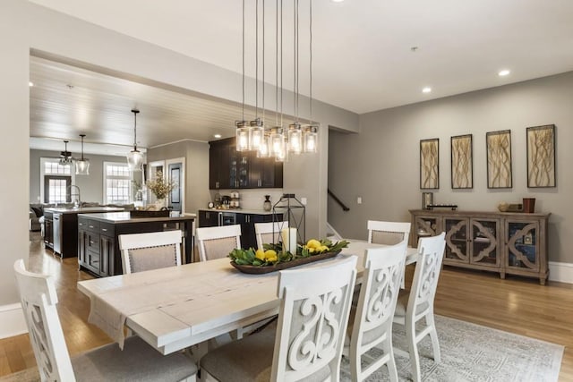 dining room with recessed lighting, baseboards, and wood finished floors